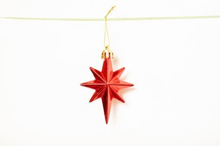 Christmas gift is hanging on isolated white backgroundの写真素材