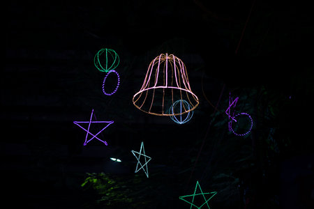 Illuminated lamps in the shape of stars on a black backgroundの写真素材