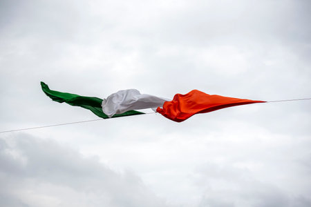 Waving flag against cloudy sky, horizontal picture.の写真素材