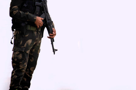 Soldier holding a rifle, closeup of photo with soft focusの写真素材