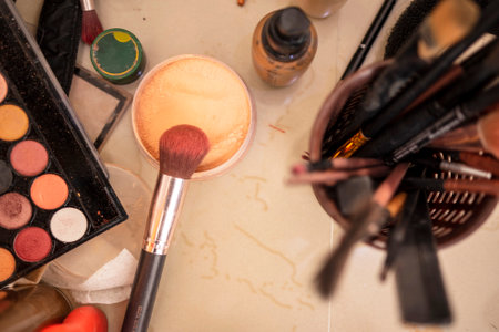 Makeup brushes and cosmetics on a marble background. Top view.の写真素材