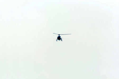 Helicopter flying in the cloudy sky. Helicopter rescue service.の写真素材