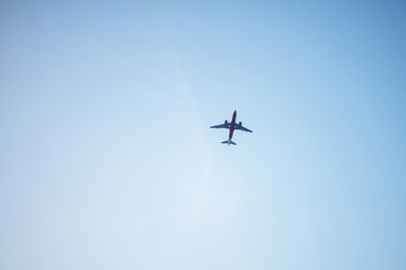 Airplane flying in the blue sky in a sunny day. Blue sky background.の写真素材