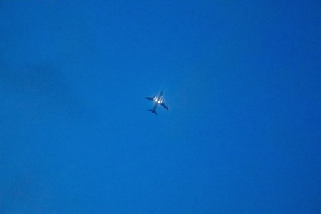airplane in the blue sky, photo as a background, digital imageの写真素材