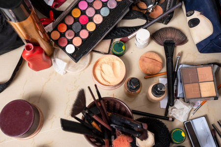 Makeup equipment are scattered on tableの写真素材