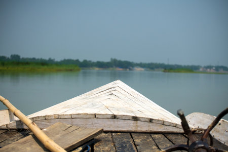 Close-up of wooden boat flowing on water in a river Ganges.の写真素材