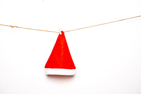 Santa hat is hanging isolated on a white background for Christmas.の写真素材