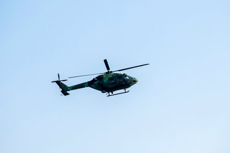 Helicopter flying approaching on isolated blue skyの写真素材