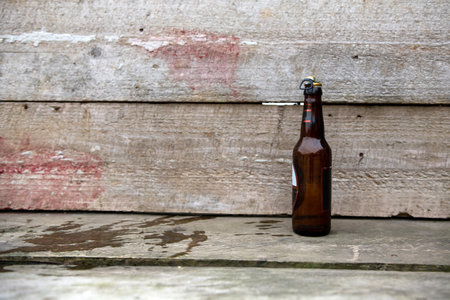 Wine bottle in a rough wooden tableの写真素材