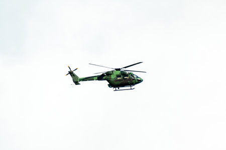 Helicopter is flying on isolated blue sky in mid-air background.の写真素材