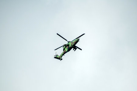 Helicopter is flying on isolated blue sky in mid-air background.の写真素材