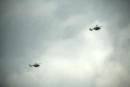Helicopter formation against isolated cloudy mid-air sky