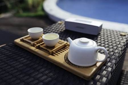 tea set beside poolの写真素材
