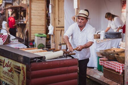 BUDAPEST, HUNGARY - OKTOBER 14, 2018: K rt skal cs Fesztiv l 2018. Bakers preparing and selling traditional hungarian pastry called kurtosh kallach in Budapest festival of Sekler cake on Oktober 12, 2018.のeditorial素材