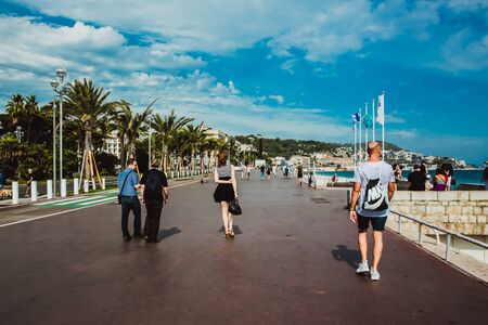 NICE, FRANCE - JUNE 26, 2017: Many tourists walk along the english promenade of French Riviera at the Mediterranean Seaのeditorial素材
