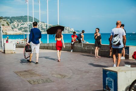 NICE, FRANCE - JUNE 26, 2017: Many tourists walk along the english promenade of French Riviera at the Mediterranean Seaのeditorial素材