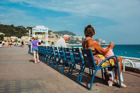 NICE, FRANCE - JUNE 26, 2017: Many tourists walk along the english promenade of French Riviera at the Mediterranean Seaのeditorial素材