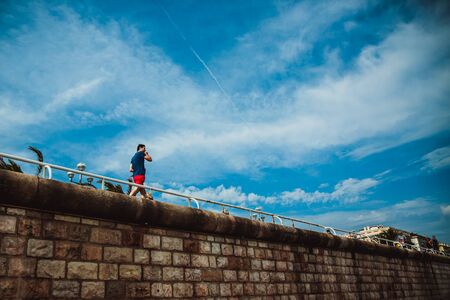 NICE, FRANCE - JUNE 26, 2017: Many tourists walk along the english promenade of French Riviera at the Mediterranean Seaのeditorial素材