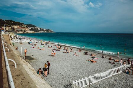 NICE, FRANCE - JUNE 26, 2017: People enjoying sunny weather on the beach of Mediterranean seaのeditorial素材