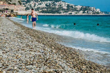 NICE, FRANCE - JUNE 26, 2017: People enjoying sunny weather on the beach of Mediterranean seaのeditorial素材