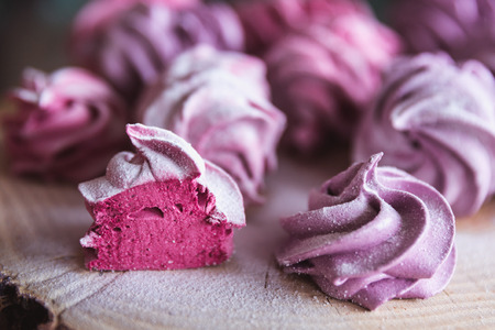 Close up of homemade cut pink zephyr or marshmallow in powdered sugar on woodenの写真素材