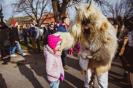 MOHACS, HUNGARY - FEBRUARY 11, 2018: Unidentified people in mask participants at the Mohacsi Busojaras, it is a carnival for spring greetings. February 11, 2018 in Mohacs, Hungaryのeditorial素材