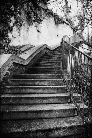 Front view of concrete stairs and rough concrete walls of an old house