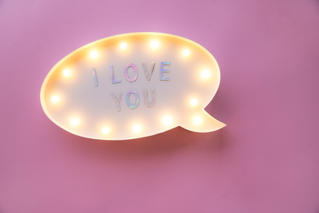 Creative Valentine Day romantic composition. flat lay love holiday celebration text I love you on lightbox on pink background with copy space for design social media blogsの写真素材