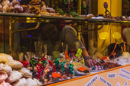 Multiple sweets on the shop shelves with price tags. Popular street food in Italyのeditorial素材