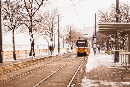 BUDAPEST, HUNGARY - 16 DECEMBER, 2018: Danube embankment with yellow tram from Buda side in winter in Budapest, Hungaryのeditorial素材