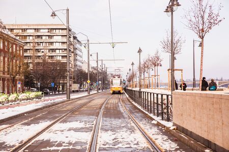BUDAPEST, HUNGARY - 16 DECEMBER, 2018: Danube embankment with yellow tram from Buda side in winter in Budapest, Hungaryのeditorial素材