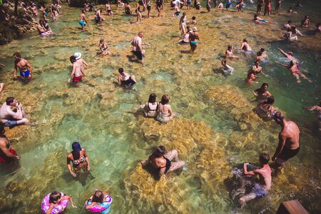 KRKA NATIONAL PARK, CROATIA - AUG 13, 2015: Plenty of tourists enjoy swimin in Krka waterfalls in the Krka National Park in Croatiaのeditorial素材