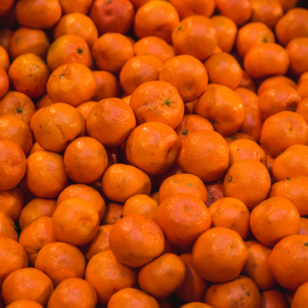 Fresh organic mandarin oranges texture in market, close-upの写真素材