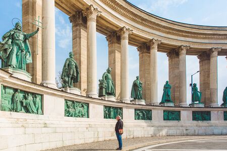 BUDAPEST, HUNGARY - APRIL 04, 2019: Many tourists stroll on the Heroes Square. Is one of the most-visited attractions in Budapest squares in Budapest, Hungary.のeditorial素材