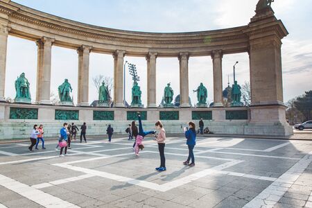 BUDAPEST, HUNGARY - APRIL 04, 2019: Many tourists stroll on the Heroes Square. Is one of the...