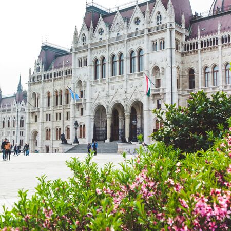 BUDAPEST, HUNGARY - APRIL 03, 2019: Tourists walking near the Parliament Hungary ,Budapestのeditorial素材