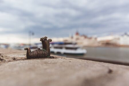 Small statue bronze worm in Budapest, popular Hungarian cartoon figure Fo kukac - chief bait worm. Made and erected by the sculptor Mihajlo Kolodkoの写真素材