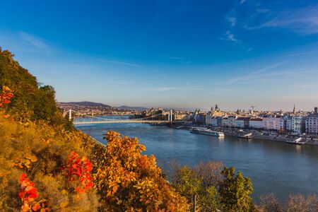 View of Budapest and the river Danube from the Citadella, Hungary at sunrise with beautiful autumn foliageの写真素材