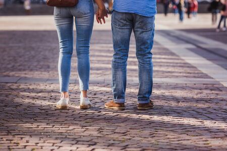 Tourist couple walking on cobblestone street vacation in europe on holiday break