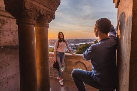 Young couple take pictures of each other on the view point from Fisherman Bastion in Budapest on...
