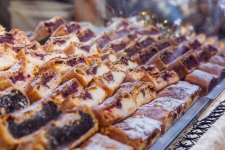 National Hungarian delicious strudel with poppy seeds and cottage cheese at the Christmas market in...