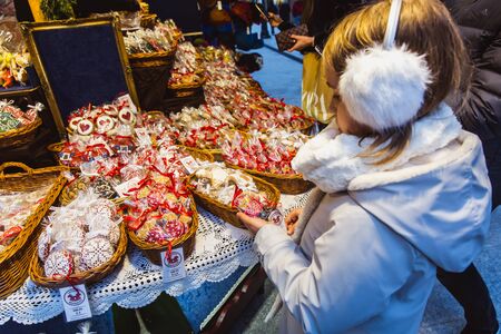 BUDAPEST, HUNGARY - NOVEMBER 08, 2019: Little girl in the beautiful Christmas Market at Vorosmarty...