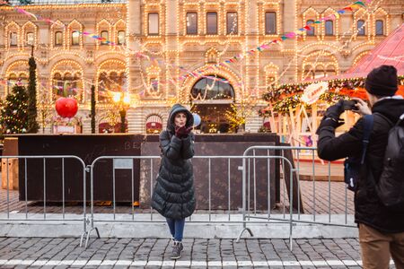 MOSCOW, RUSSIA- DECEMBER 16, 2019: Tourists and local people enjoying the beautiful New Year decoration near GUM shop on Red Square in Moscowのeditorial素材
