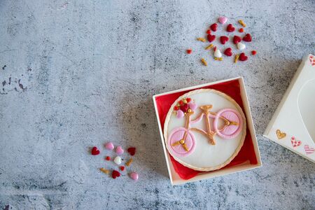Baking cookies Heart and bike with topping and icing in a gift box. Top View on grey background