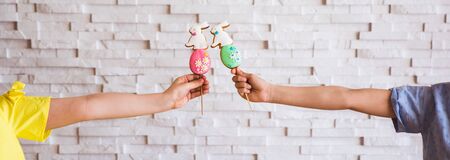 Kids hands holding easter colorful gingerbread inside