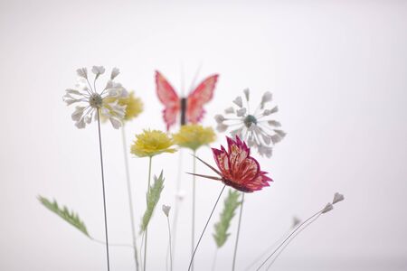 Spring composition with paper flowers and butterfly on white backgroundの写真素材