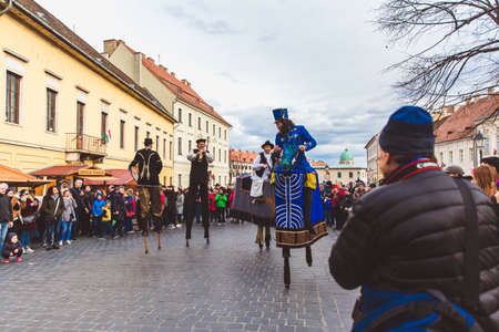 BUDAPEST - MARCH 15: Performance of artists on stilts on a street in the Buda Castle on the day of the Hungarian National Revolution on March 15, 2019 in Budapest.のeditorial素材