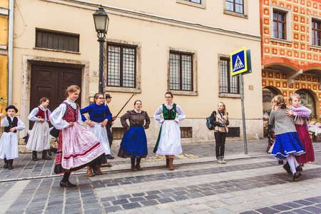 BUDAPEST - MARCH 15, 2019: Hungarian folk dance group of children on a street in the Buda Castle on the day of the Hungarian National Revolution on March 15, 2019 in Budapest.のeditorial素材
