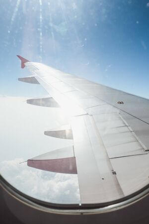 View of beautiful cloud and wing of airplane from windowの写真素材