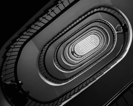 Black and white photo of old spiral staircase, spiral stairway inside old house in Budapest, Hungary, Europeの写真素材